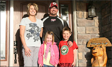 Mike, Tiff, Drew and Kyleigh Tangen by their front door