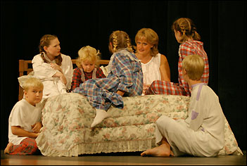 Maria with von Trapp children on her bed