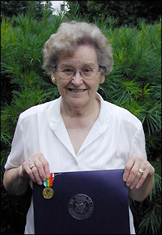 Viola Dreste holding her husband's medal