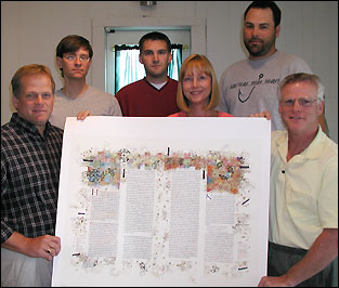 ColorMax staff holding printed page of Bible