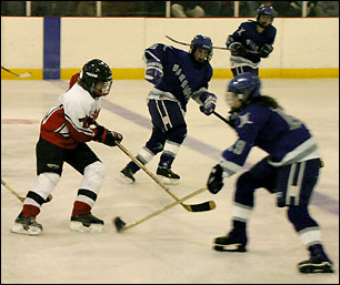 Tori skates the puck down ice