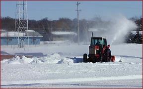 Blowing snow off baseball field