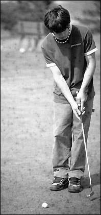 Tom Stoneburner taking a practice swing with the putter