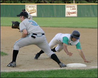 Russ Leyendecker sliding back to first