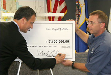 Rep. Mark Kennedy signing Hwy. 23 check